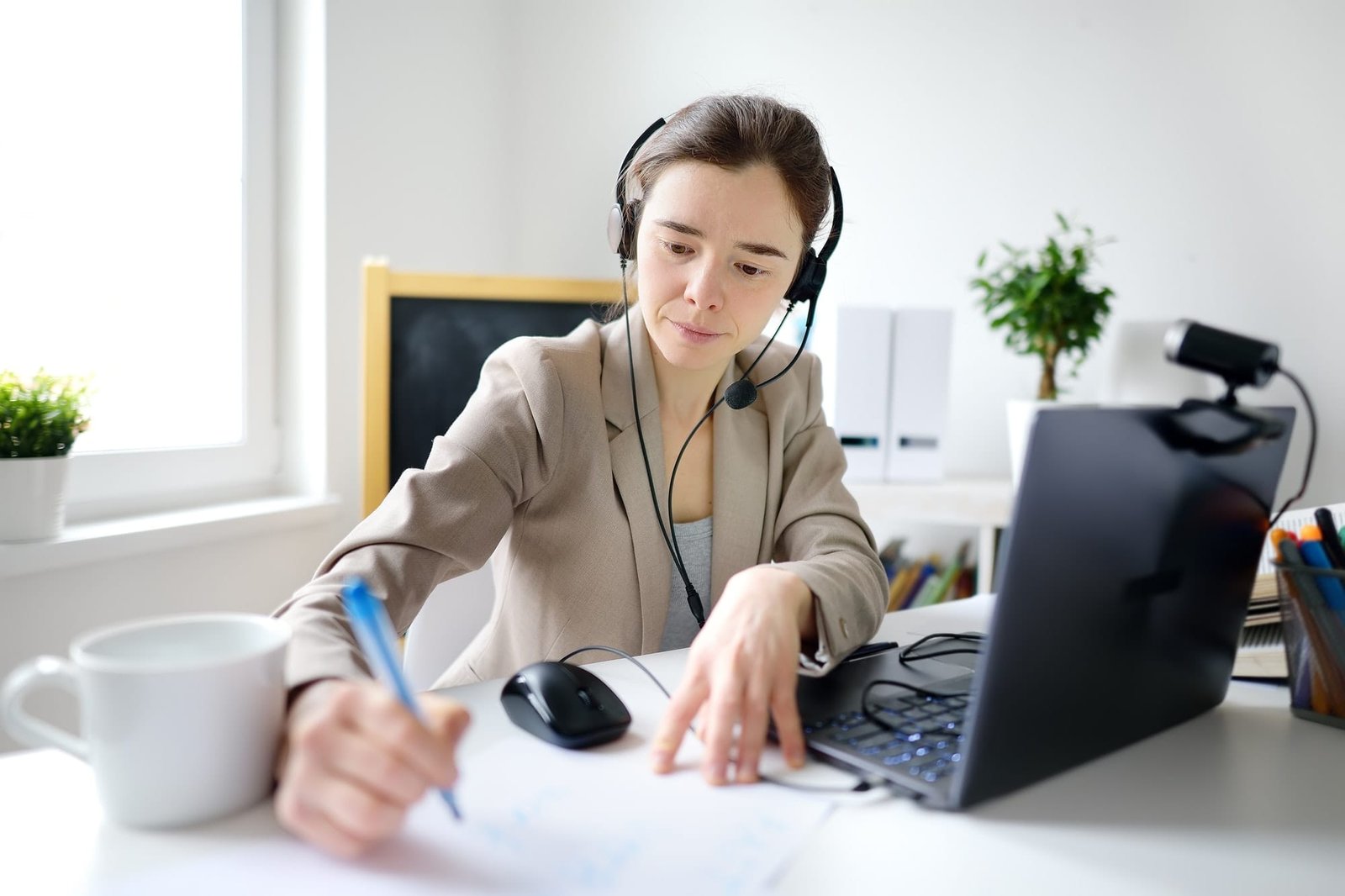 young-woman-is-learning-language-with-laptop-computer-camcorder-and-headphone-online-at-home-.jpg